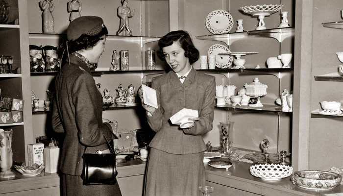 Mid-century Lasell students work at a retail counter