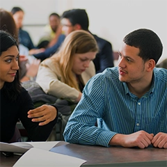 college students in a classroom talking during class