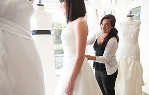 girl altering a white wedding dress