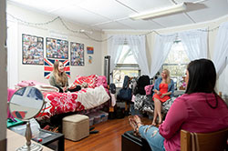 three girls sitting in a dorm room