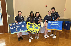 students holding posters at orientation