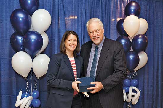 Rebecca Oliver, director of digital marketing, and Michael B. Alexander, president of Lasell University, at the Human Resources Employee Recognition Awards in Winter 2019. 