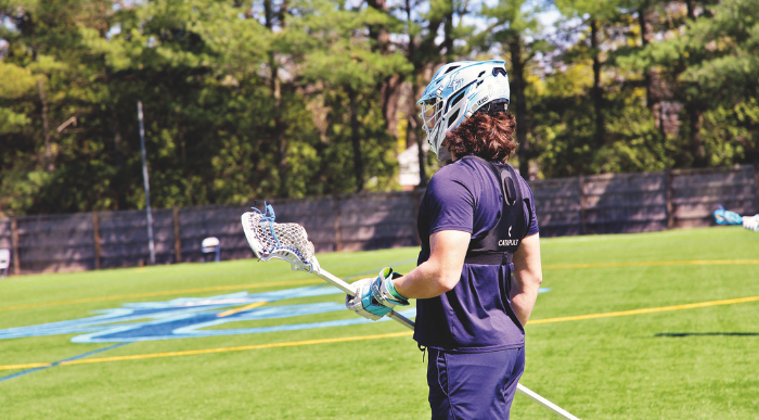 Lasell lacrosse player wears a Catapult vest while training