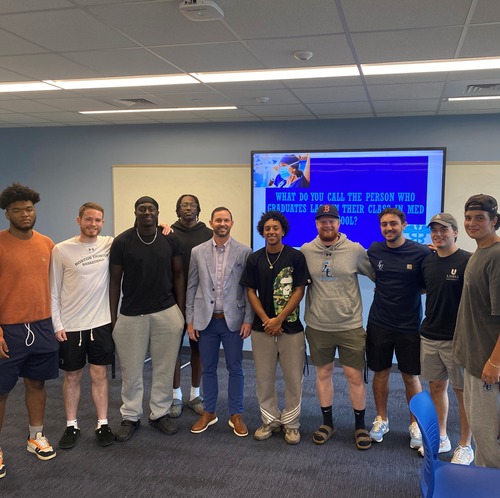 Jeremy Davis '07 with current Lasell student-athletes on campus