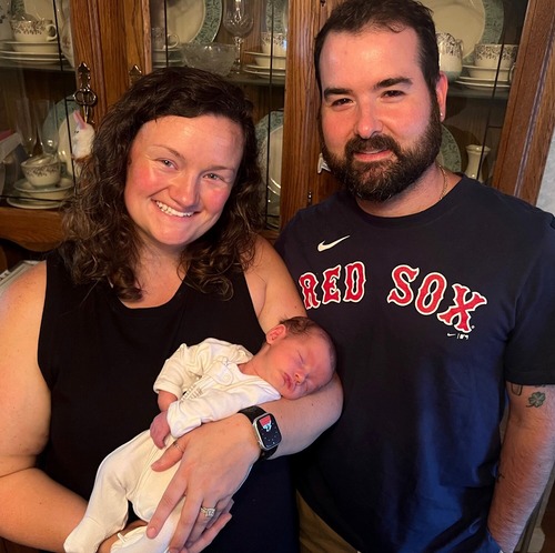 Kaitlyn Quinn Richards '14 G'15 with husband, John, and child, Quinn. 