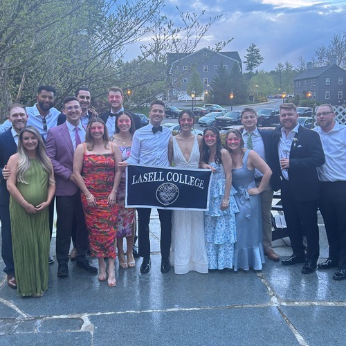 Taylor Yandow '18 and Derek McMahon '18 at their wedding with Lasell community members