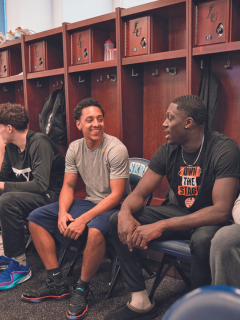 Students in the men's athletic team room at Lasell University