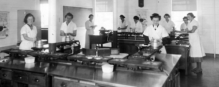 Women cooking in a large school kitchen