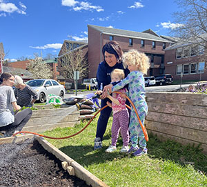 Community members participate in an intergenerational garden planting activity