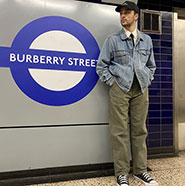 Male college student standing in a Blueberry train station in London